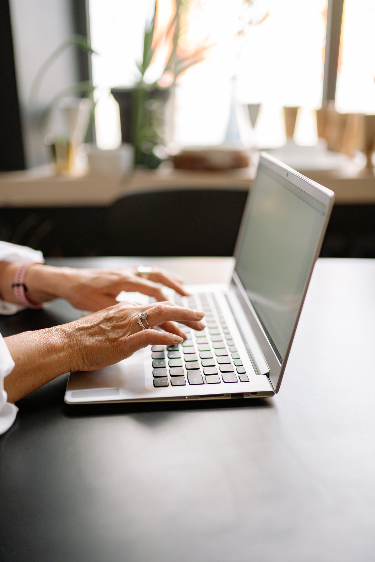 Person Using a Laptop on Table